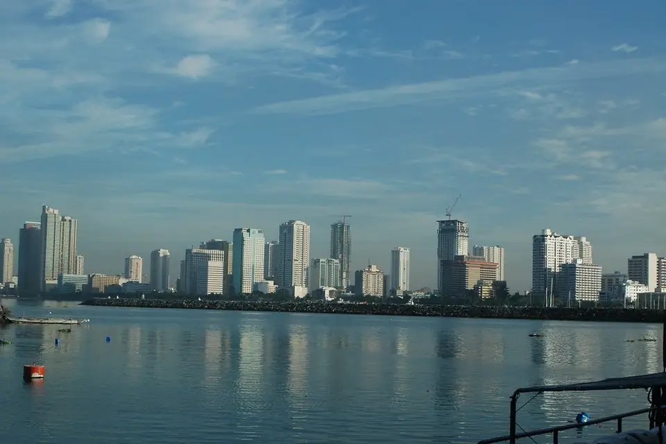 Manila city skyline across the bay at dusk